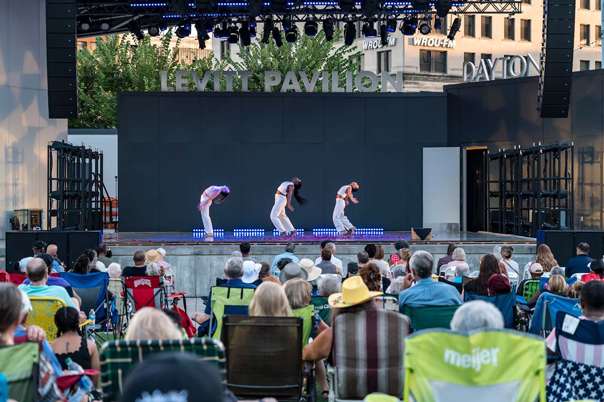 Dancers on stage performing in front of a crowd